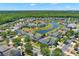 Beautiful aerial view of the neighborhood with homes surrounding a large pond and lush landscaping at 4739 Cumbrian Lakes Dr, Kissimmee, FL 34746