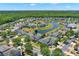 Aerial view of home in a community with a pond and lush landscaping at 4739 Cumbrian Lakes Dr, Kissimmee, FL 34746