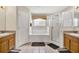 Primary bathroom showcasing double vanities, a glass-enclosed shower, and a soaking tub at 4739 Cumbrian Lakes Dr, Kissimmee, FL 34746
