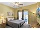 Comfortable bedroom with a ceiling fan, outdoor access, and a TV for relaxation at 4739 Cumbrian Lakes Dr, Kissimmee, FL 34746