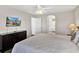 Bright bedroom with a large bed, dresser with a TV, and access to the ensuite bathroom at 4739 Cumbrian Lakes Dr, Kissimmee, FL 34746
