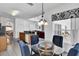 Bright dining area features a glass table, blue upholstered chairs, and a view of the living room at 4739 Cumbrian Lakes Dr, Kissimmee, FL 34746
