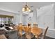 Cozy dining area with wooden table, chandelier, and open view to the living room and staircase at 4739 Cumbrian Lakes Dr, Kissimmee, FL 34746