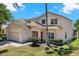 Charming two-story home featuring a well-maintained lawn and inviting curb appeal on a sunny day at 4739 Cumbrian Lakes Dr, Kissimmee, FL 34746