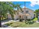 Two-story home with a well-manicured lawn, showcasing the home's front exterior and curb appeal at 4739 Cumbrian Lakes Dr, Kissimmee, FL 34746