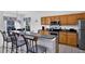 Kitchen with bar stool seating, wood cabinets, and stainless steel appliances at 4739 Cumbrian Lakes Dr, Kissimmee, FL 34746