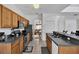 Well-equipped kitchen featuring wooden cabinets and stainless steel appliances overlooking the living area at 4739 Cumbrian Lakes Dr, Kissimmee, FL 34746