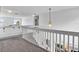 Upstairs loft space with white railings, views of the first floor, and natural light at 4739 Cumbrian Lakes Dr, Kissimmee, FL 34746
