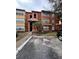 Cozy condominium with a terracotta facade, well-kept landscaping, and assigned parking at 5160 Conroy Rd # 26, Orlando, FL 32811