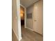 Hallway view leading to bathroom with a dark wood vanity and granite countertop at 5160 Conroy Rd # 26, Orlando, FL 32811