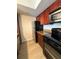 Efficient kitchen layout, featuring stainless steel appliances and modern wood cabinetry at 5160 Conroy Rd # 26, Orlando, FL 32811