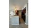 Open kitchen design with bar seating, stainless appliances, and wood-look laminate flooring at 5160 Conroy Rd # 26, Orlando, FL 32811