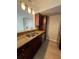 Stylish kitchen features a breakfast bar, stainless steel sink, and hanging pendant lights at 5160 Conroy Rd # 26, Orlando, FL 32811