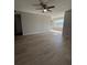 Spacious living room with ceiling fan, hardwood floors, and natural light from the windows at 5160 Conroy Rd # 26, Orlando, FL 32811