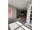 Bright living room features light gray walls and wood-look floors, with a kitchen area in the background at 5160 Conroy Rd # 26, Orlando, FL 32811