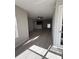 Open-concept living area with hardwood floors, ceiling fan, and seamless flow to kitchen at 5160 Conroy Rd # 26, Orlando, FL 32811