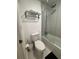 Bathroom features a toilet, towel rack, and shower with glass door at 5245 W Irlo Bronson Memorial Hwy # 276, Kissimmee, FL 34746