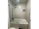 Bright bathroom featuring a glass-enclosed shower with rainfall showerhead and wall-mounted dispensers at 5245 W Irlo Bronson Memorial Hwy # 276, Kissimmee, FL 34746