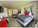 Bright bedroom featuring two beds with stylish gray comforters and a mounted television at 5245 W Irlo Bronson Memorial Hwy # 276, Kissimmee, FL 34746