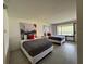 Well-lit bedroom featuring two beds, modern decor, and a view to the outside at 5245 W Irlo Bronson Memorial Hwy # 276, Kissimmee, FL 34746
