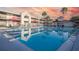 Outdoor swimming pool surrounded by lounge chairs and red umbrellas, perfect for relaxation at 5245 W Irlo Bronson Memorial Hwy # 276, Kissimmee, FL 34746