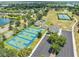 Aerial view showcasing community basketball courts, parking, and recreational facilities by lake at 5321 Los Palma Vista Dr, Orlando, FL 32837