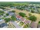 Aerial view of suburban neighborhood with tree coverage and a large field at 5321 Los Palma Vista Dr, Orlando, FL 32837