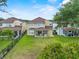 Aerial view of the backyard featuring a lawn and covered patio with outdoor kitchen at 5321 Los Palma Vista Dr, Orlando, FL 32837