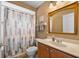 Cozy bathroom with a shower-tub combo and wooden vanity at 5321 Los Palma Vista Dr, Orlando, FL 32837