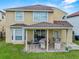 Back exterior of home showcasing a covered patio with an outdoor kitchen at 5321 Los Palma Vista Dr, Orlando, FL 32837