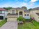 Inviting two-story home with a brick driveway, manicured lawn, and a two-car garage at 5321 Los Palma Vista Dr, Orlando, FL 32837