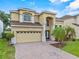 Charming home featuring a well-maintained yard, brick driveway, and two-car garage at 5321 Los Palma Vista Dr, Orlando, FL 32837