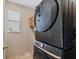 Modern laundry room featuring a stacked washer and dryer and built in cabinetry at 5321 Los Palma Vista Dr, Orlando, FL 32837