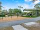 Community playground with swings, slides, and a shaded play area for children at 5321 Los Palma Vista Dr, Orlando, FL 32837