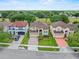 Street view of three homes with manicured lawns, driveways and mature trees at 5321 Los Palma Vista Dr, Orlando, FL 32837