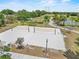 Sandy volleyball court with nets, surrounded by trees and walking paths at 5321 Los Palma Vista Dr, Orlando, FL 32837