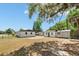 A spacious backyard features multiple outbuildings, with ample lawn space, and mature tree coverage at 620 Plum Ln, Altamonte Springs, FL 32701