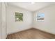 This bedroom offers sleek wood-look floors, fresh white paint, and two windows for natural light at 620 Plum Ln, Altamonte Springs, FL 32701