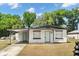 Charming single-story home with a carport, light blue doors, and fresh exterior paint under a sunny sky at 620 Plum Ln, Altamonte Springs, FL 32701