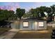 Charming single-story home at twilight, featuring a covered carport, light blue door and fresh exterior paint at 620 Plum Ln, Altamonte Springs, FL 32701