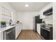 Modern kitchen featuring sleek countertops, stainless steel appliances, white cabinetry, and wood-look floors at 620 Plum Ln, Altamonte Springs, FL 32701