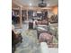 Open-concept living space with a mix of seating, a cozy atmosphere, and an adjoining eat-in kitchen at 6419 Lakeville Rd, Orlando, FL 32818