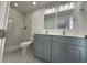 Elegant bathroom with double vanity, marble shower, and modern lighting at 705 Wood Ln, Kissimmee, FL 34759