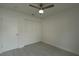 Well-lit bedroom featuring a ceiling fan, large window, and closet at 705 Wood Ln, Kissimmee, FL 34759