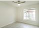 Bright bedroom featuring a ceiling fan, large window, and neutral wall paint at 705 Wood Ln, Kissimmee, FL 34759