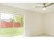 This bedroom features a glass sliding door to the backyard area and ceiling fan at 705 Wood Ln, Kissimmee, FL 34759