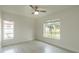This bedroom is filled with natural light and has two large windows and a ceiling fan at 705 Wood Ln, Kissimmee, FL 34759