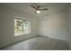 Bright bedroom featuring a ceiling fan, large window with natural light, and closet at 705 Wood Ln, Kissimmee, FL 34759