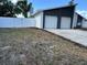 Beautiful home featuring a two-car garage, modern white exterior, and a white privacy fence at 705 Wood Ln, Kissimmee, FL 34759