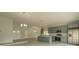 Bright open-concept kitchen with an island, stainless steel appliances, and gray cabinets at 705 Wood Ln, Kissimmee, FL 34759